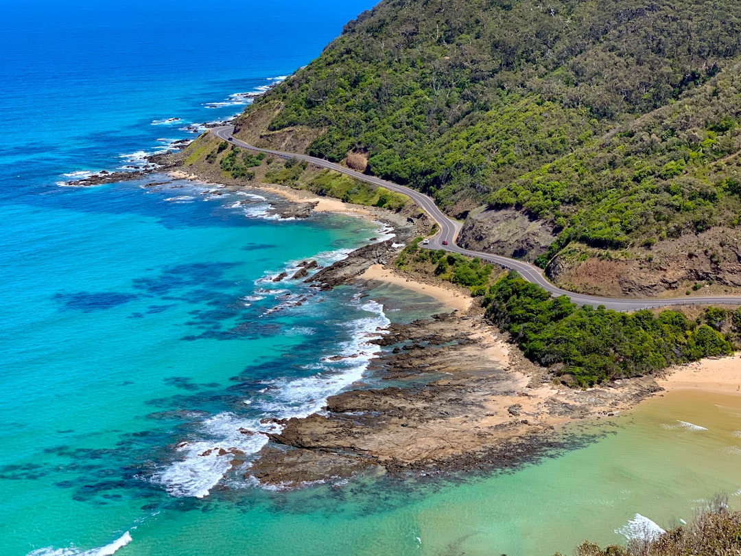 aerial view of green mountain beside blue sea during daytime